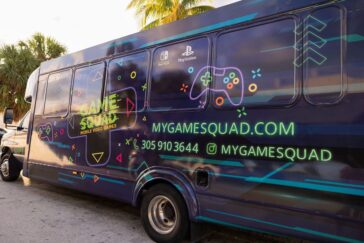 Kids playing PS5 and Xbox Series X on Pro HD screens inside the air-conditioned My Game Squad truck