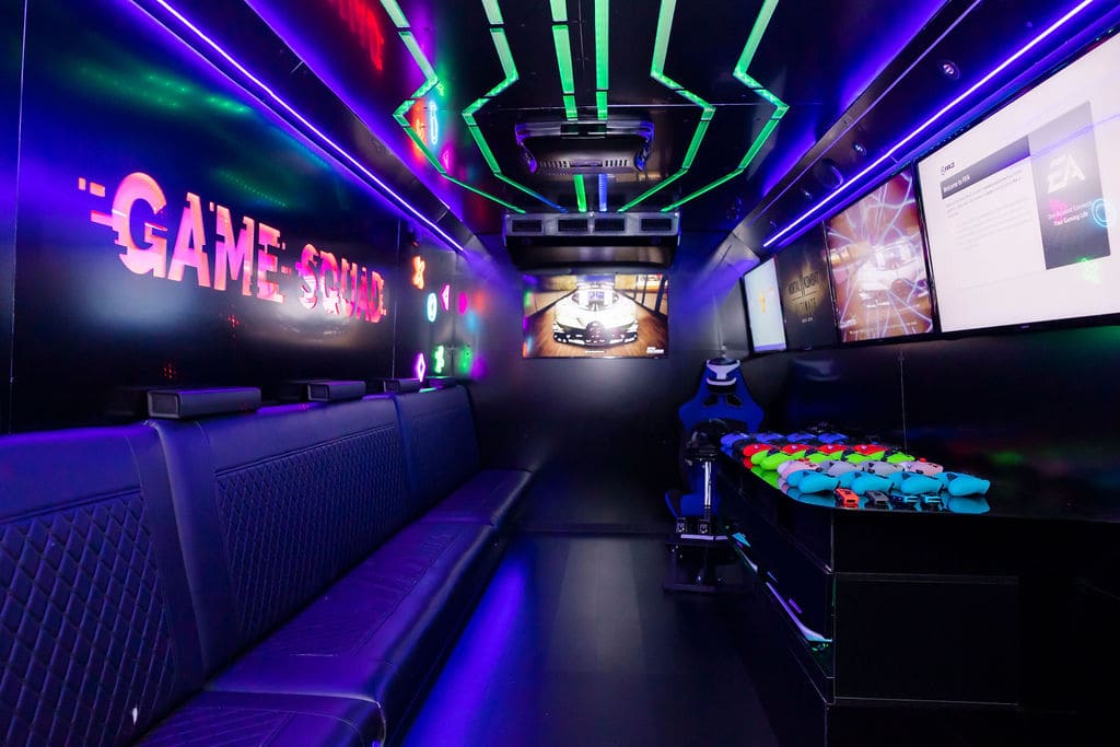 Tweens and teens gaming on pro HD screens inside the My Game Squad truck